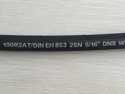 A section of SAE 100 R2 AT hydraulic hose.