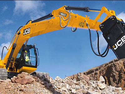 A yellow crane is working with hydraulic hoses installed on it.