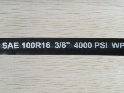 A section of SAE 100 R16 hydraulic hose of 4000 psi working pressure is on the ground.