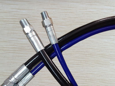 Two SAE 100 R7 hydraulic hose assemblies are on the floor.