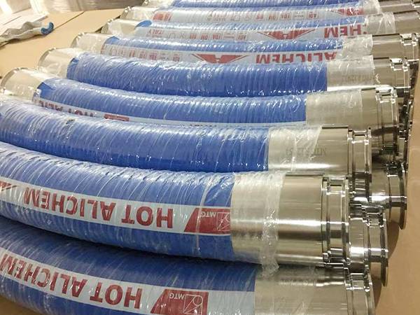 Several foo grade rubber hose assemblies on the ground.