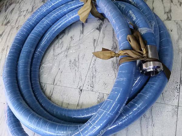 A roll of food and beverage rubber hose on the ground.