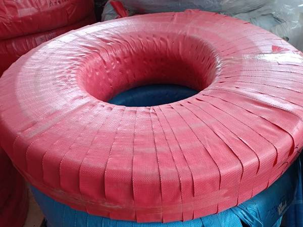 Several bundles of food rubber hoses are packed with woven bags.