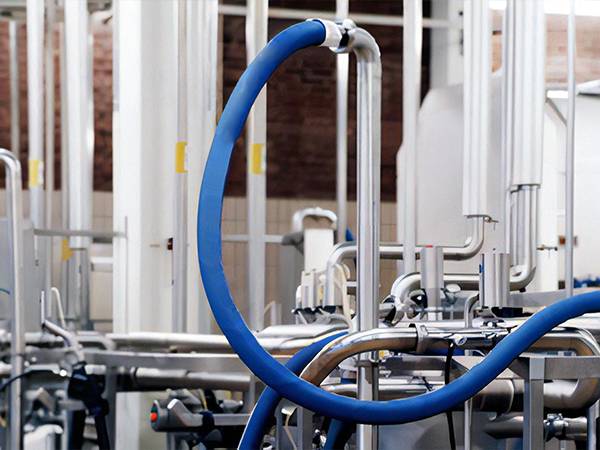 Several food rubber hoses are transferring juice.